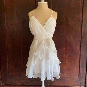 White flowy dress with ruffle bottom